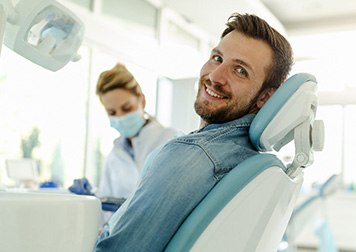 Man smiling while sitting in treatment chair