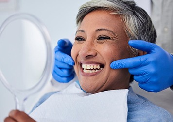 a patient smiling with her new dental implants