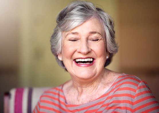 Woman smiling with her eyes closed