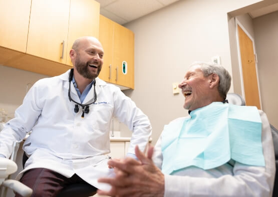 Doctor Sorrentino laughing with periodontal patient