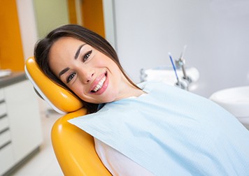 Woman smiling while sitting in treatment chair
