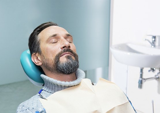 Male periodontal patient with beard under effects of oral conscious sedation