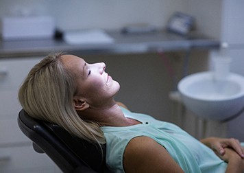 Relaxed woman sitting back in treatment chair
