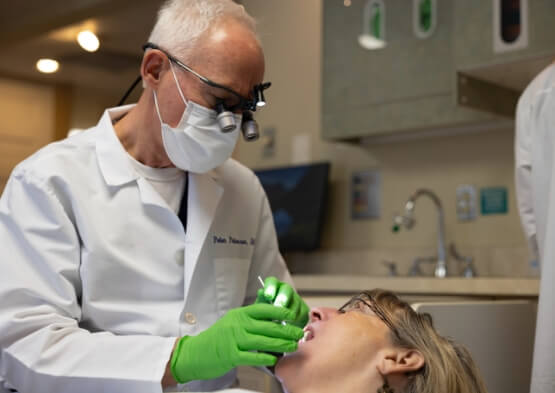 Periodontist treating dental patient